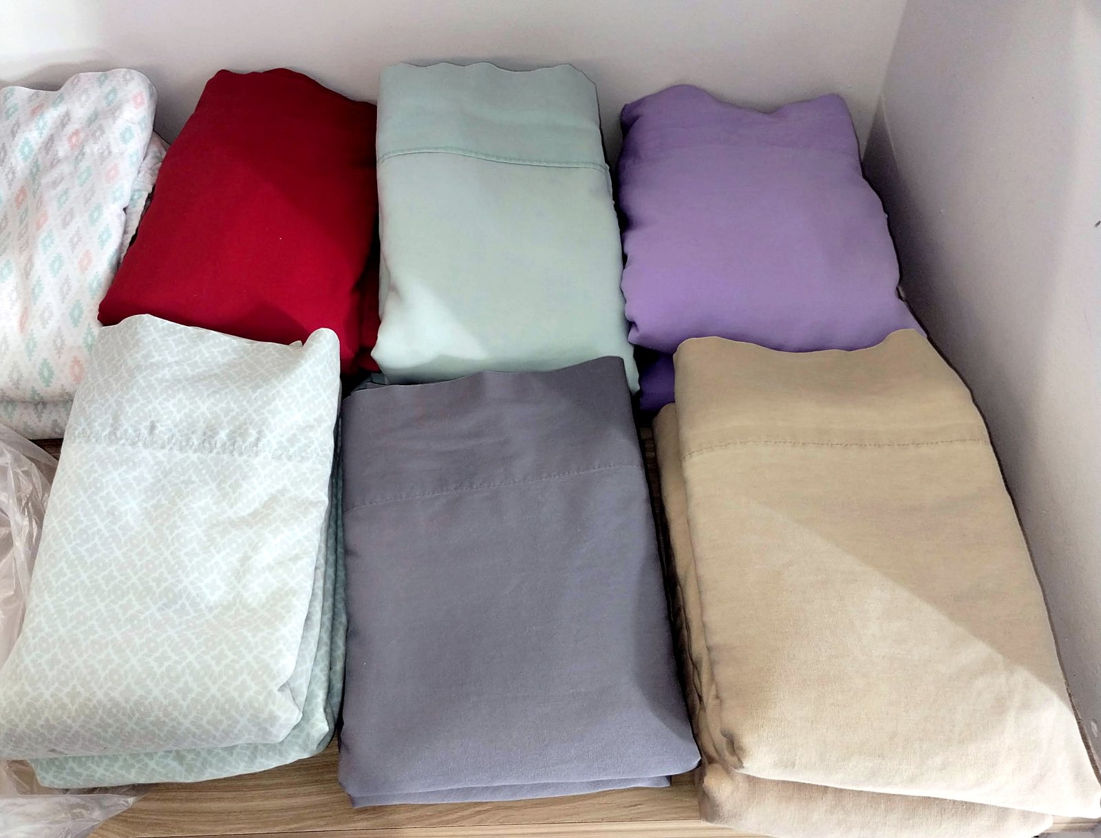 Sheets and linens folded into neat stacks after a wash and fold