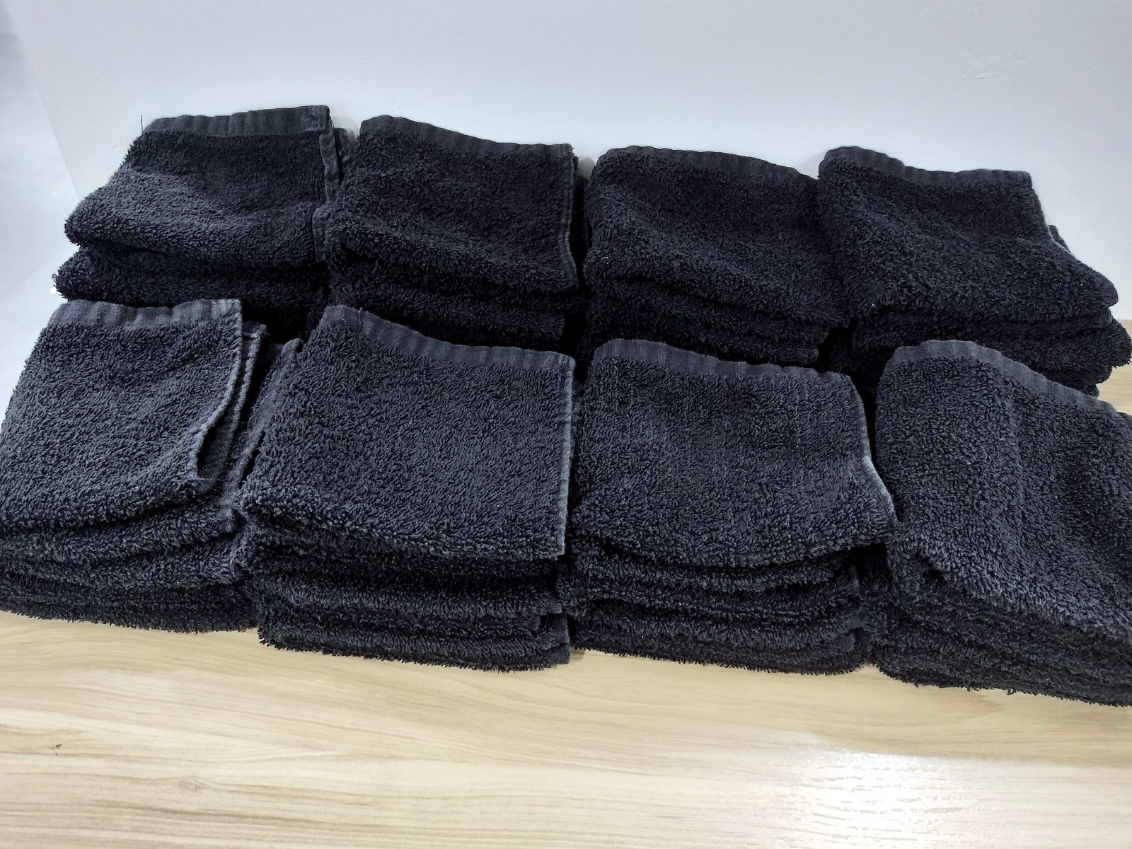 A stack of folded black salon towels